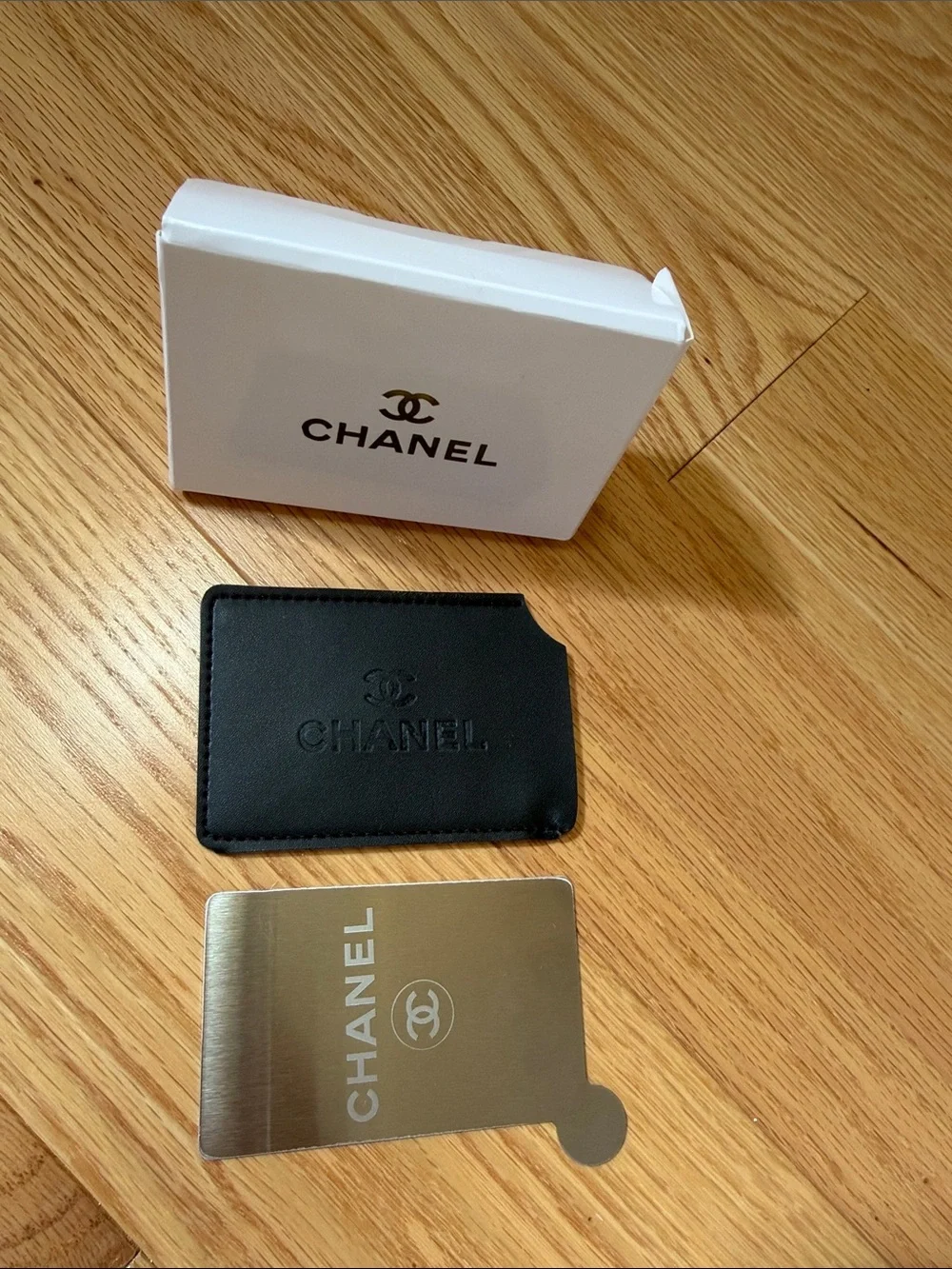 Chanel black card case with mirror.